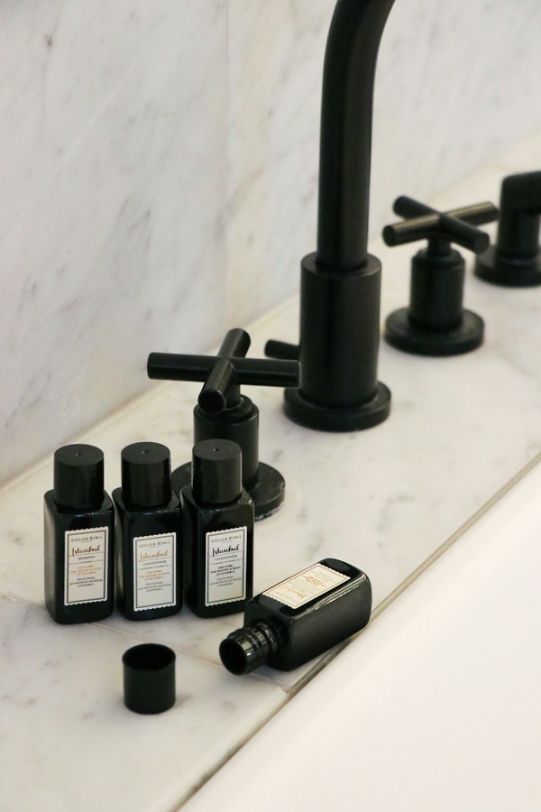 Soap dispensers and accessories on a hotel bathroom vanity