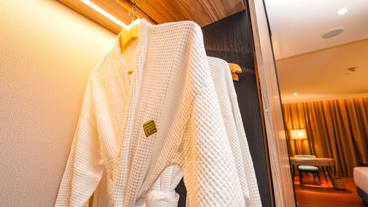 A bathrobe hanging in a hotel room