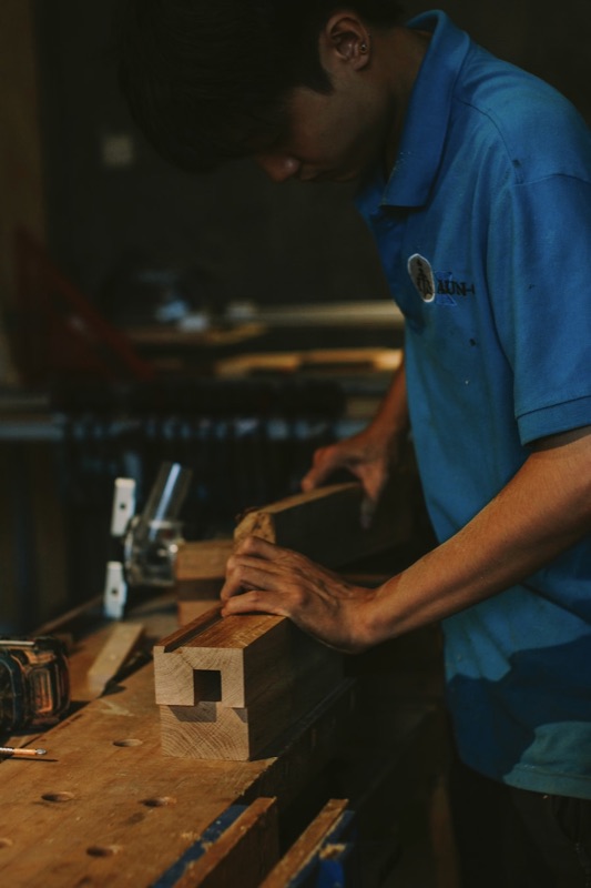 A maker cutting stock to a new size at a workbench