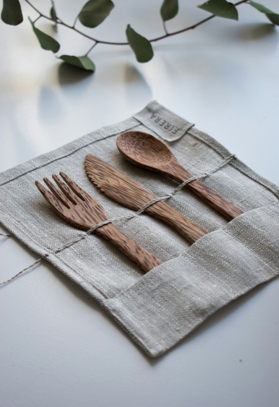 Bamboo fork, knife and spoon on a neutral background
