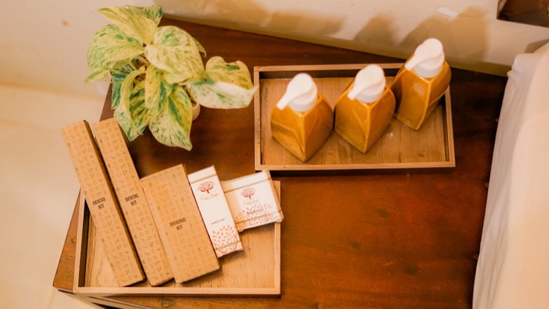Wrapped hotel soap bars on a wooden surface
